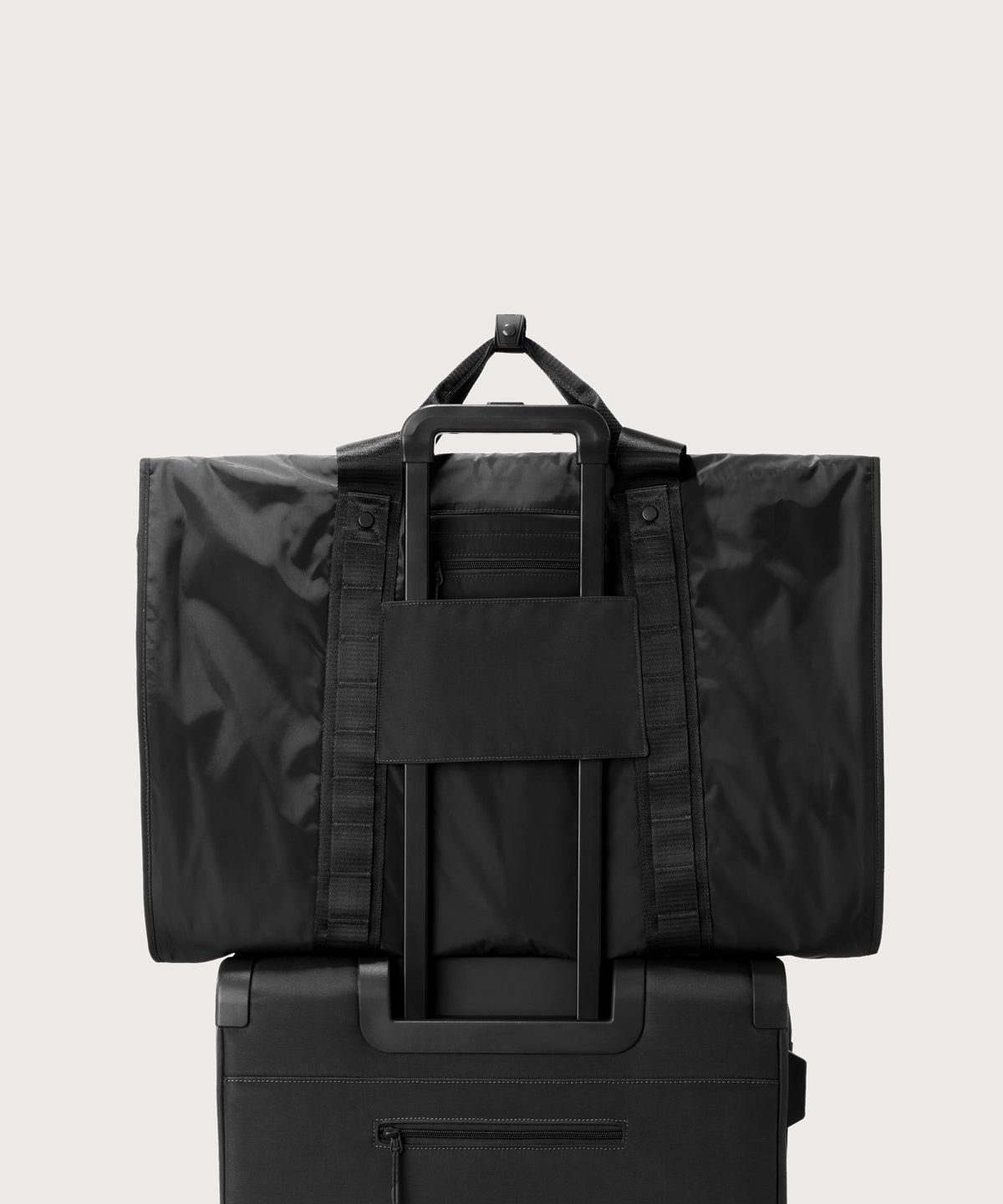 Back view of Capri garment bag in onyx on luggage handle