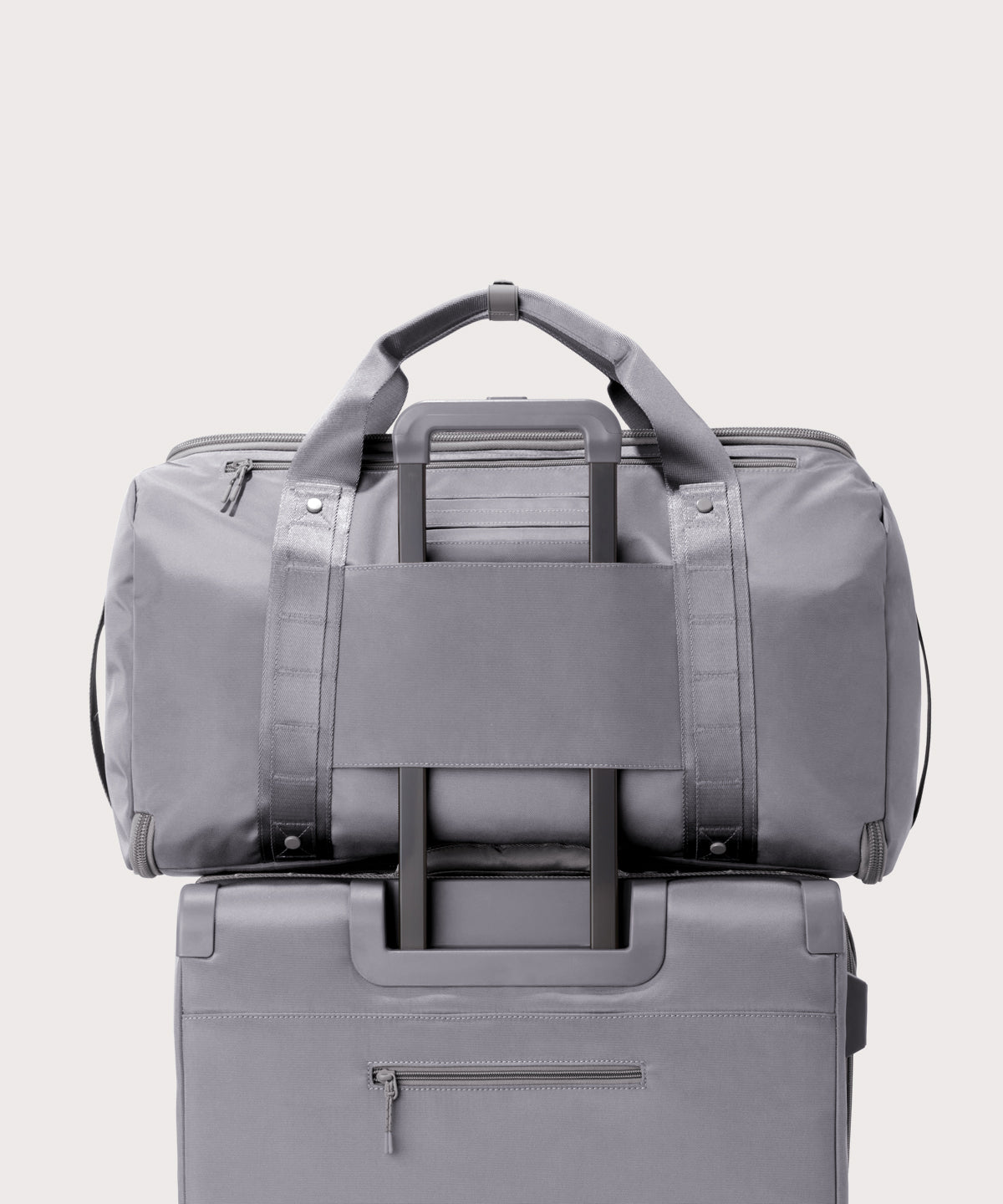 Back view of Monaco garment duffle in a light grey on luggage handle