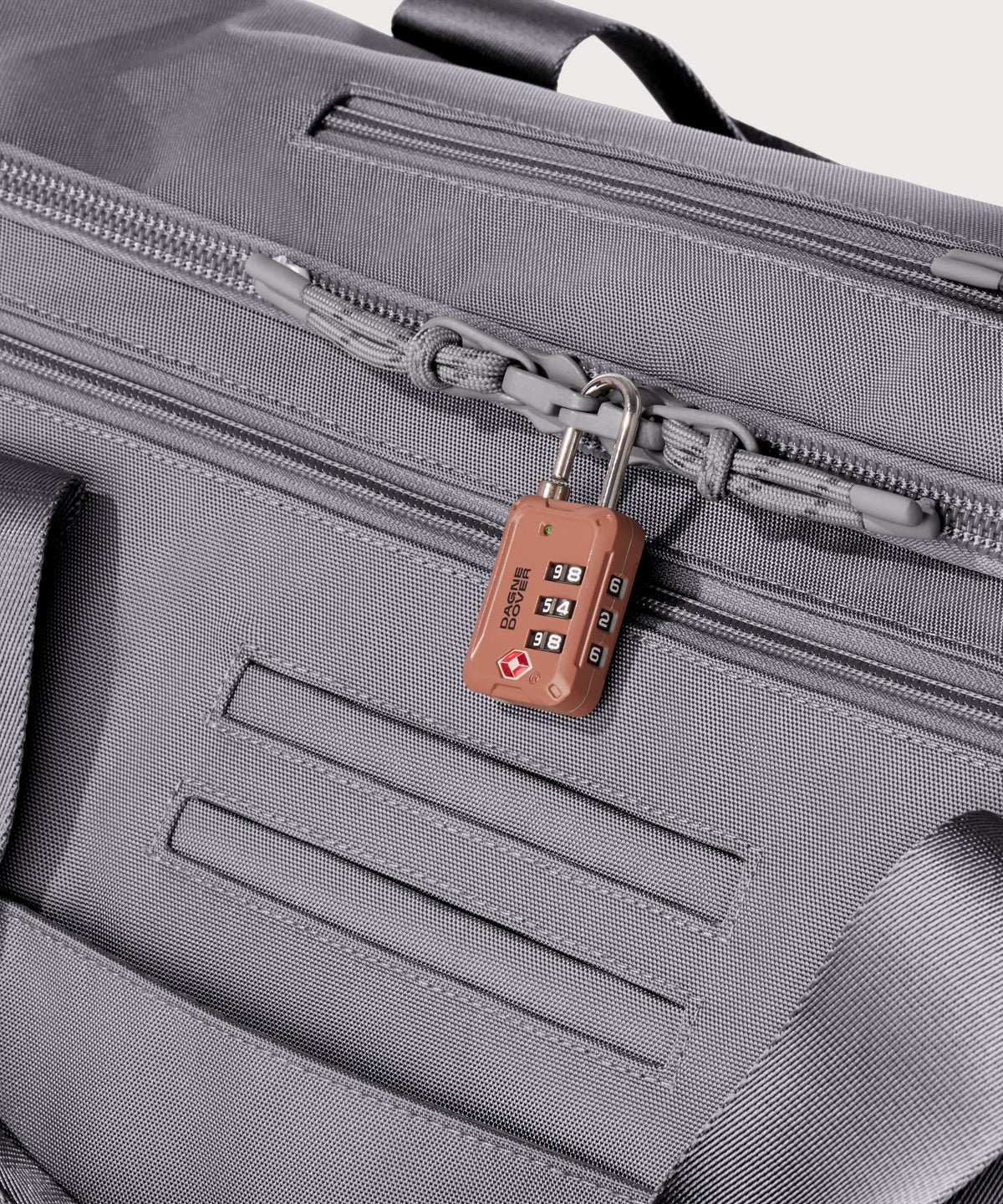 Detail shot of Monaco garment duffle in a light grey lockable zipper heads. Lock not included.
