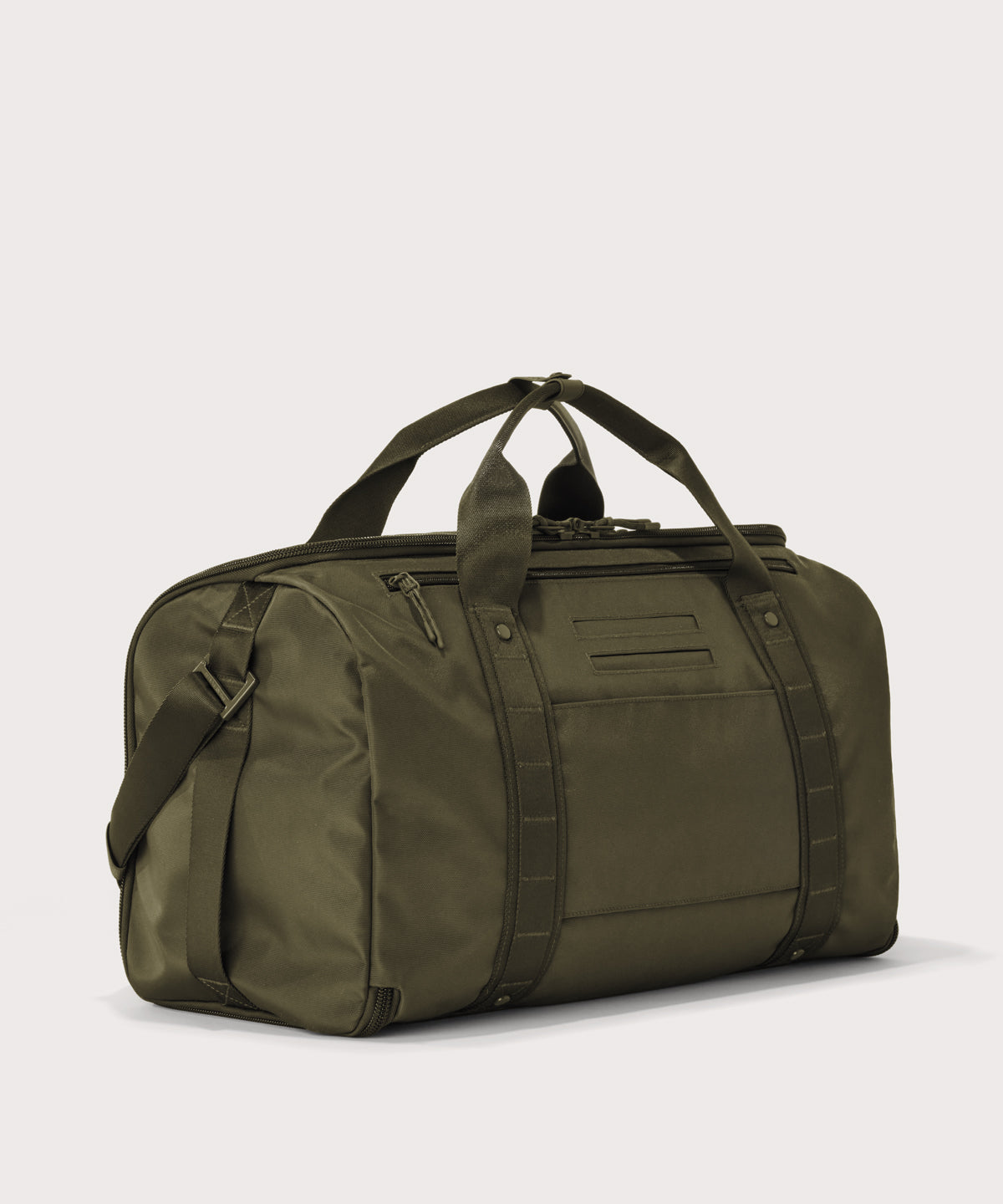 3/4 back view of Monaco garment duffle in dark green showing back zippered tech pocket and phone/passport pockets
