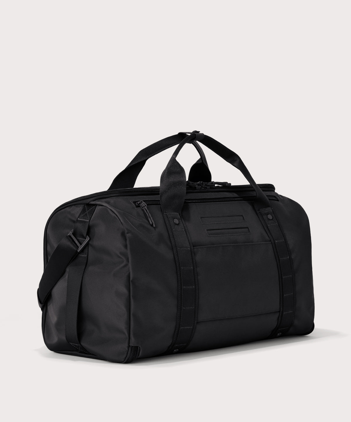 3/4 back view of Monaco garment duffle in black showing back zippered tech pocket and phone/passport pockets
