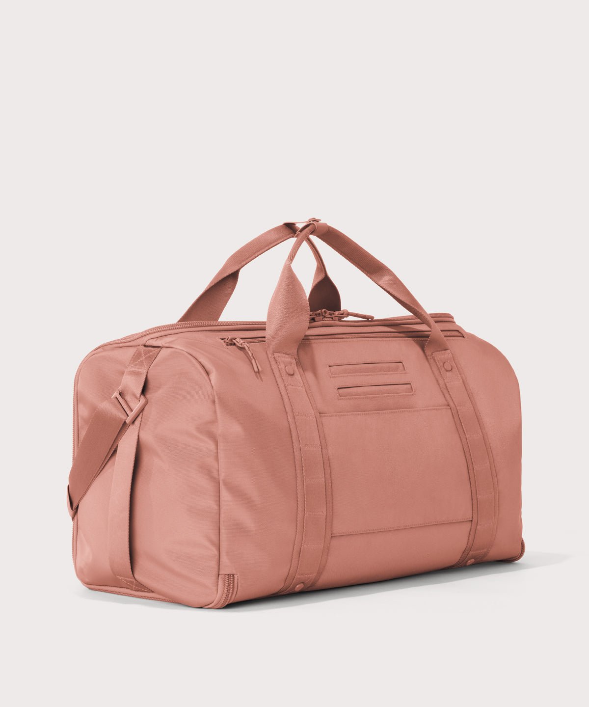 3/4 back view of Monaco garment duffle in warm dust showing back zippered tech pocket and phone/passport pockets
