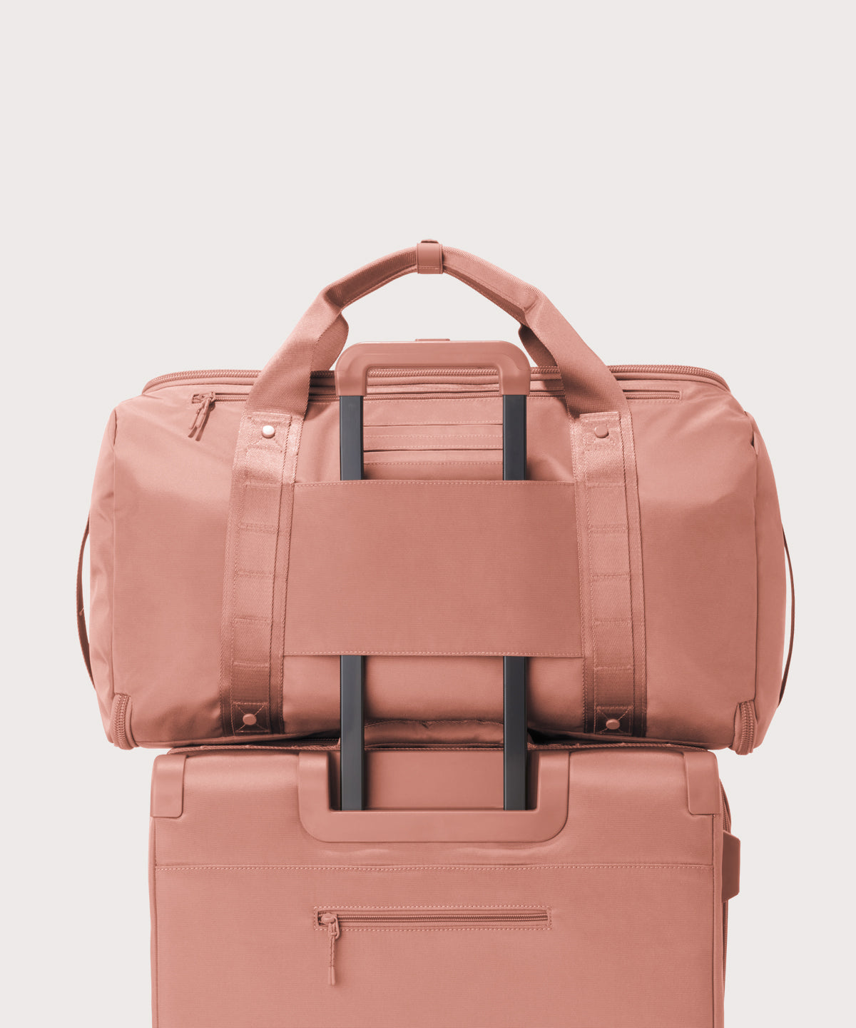 Back view of Monaco garment duffle in warm dust on luggage handle