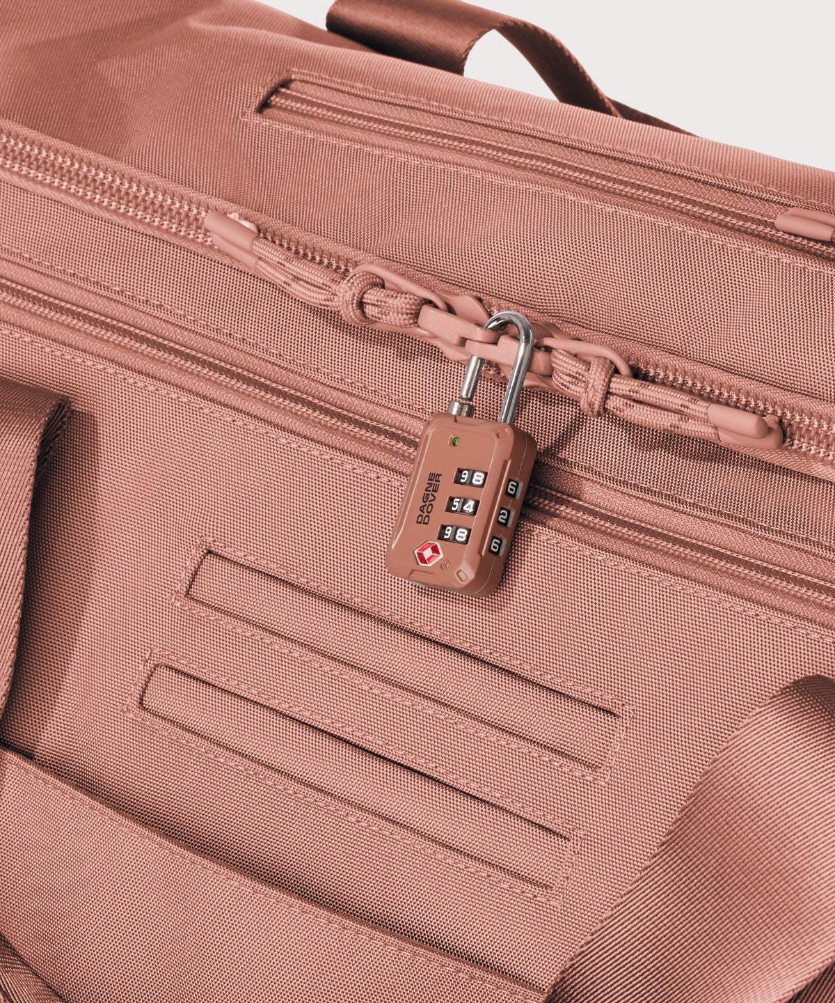 Detail shot of Monaco garment duffle in warm dust lockable zipper heads. Lock not included.
