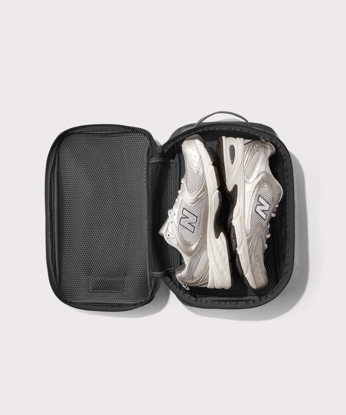 medium Roma packing cube in carbon black open with jeans inside
