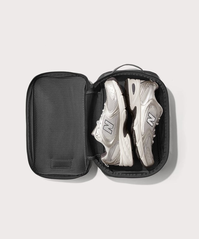 medium Roma packing cube in carbon black open with jeans inside
