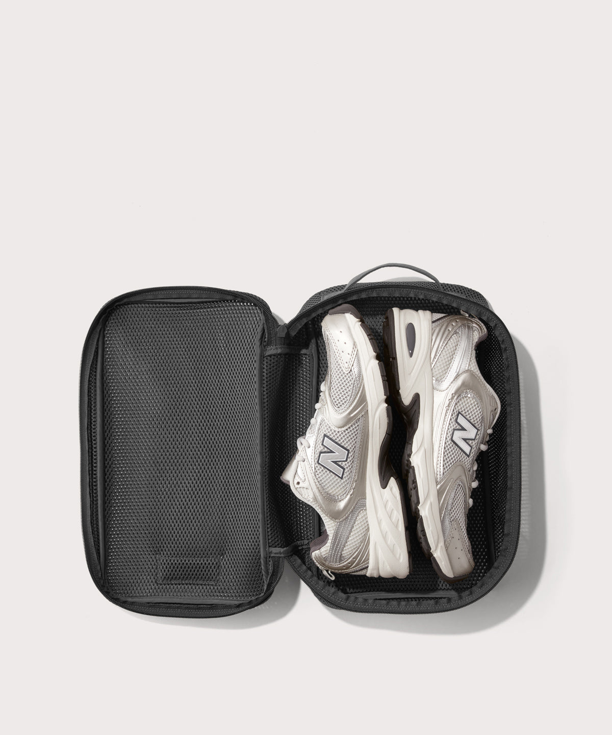 medium Roma packing cube in carbon black open with jeans inside