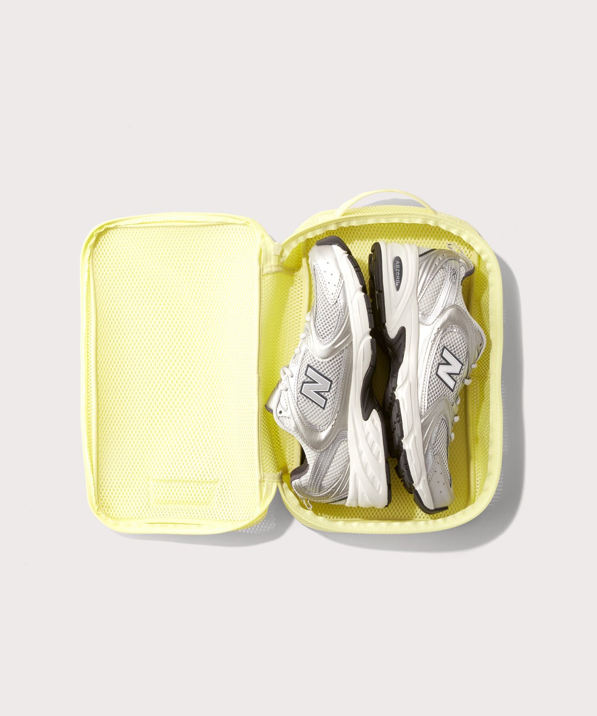 medium Roma packing cube in citrine open with jeans inside

