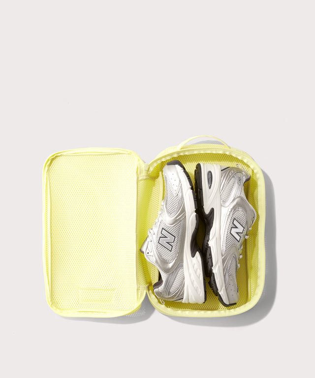 medium Roma packing cube in citrine open with jeans inside
