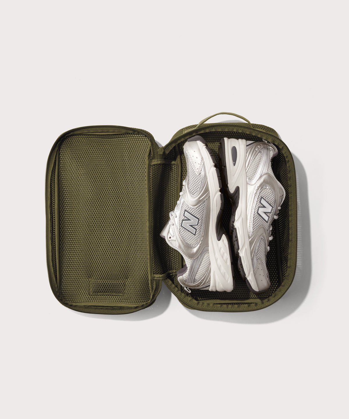 medium Roma packing cube in dark green open with jeans inside
