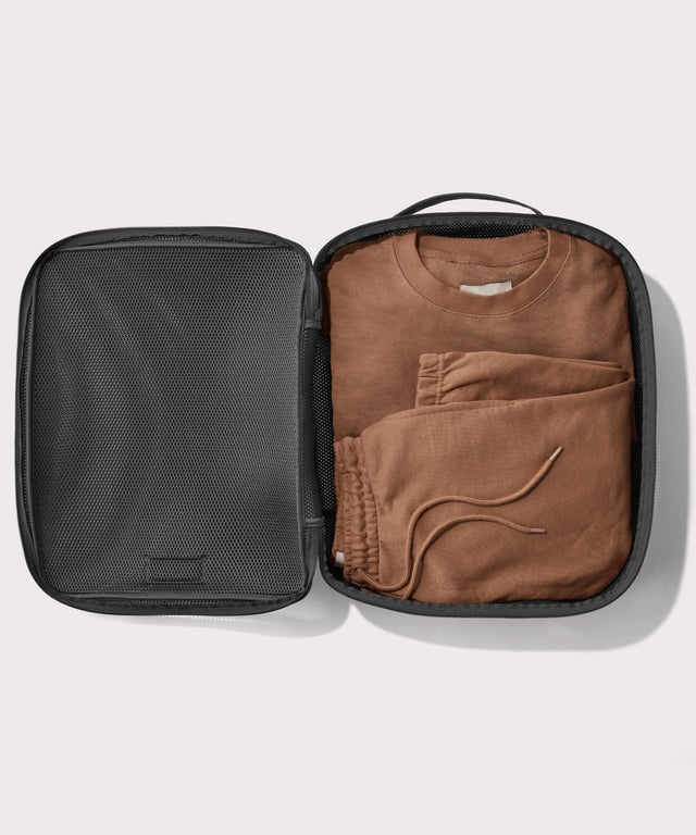 extra large Roma packing cube in carbon black open with sweatsuit inside
