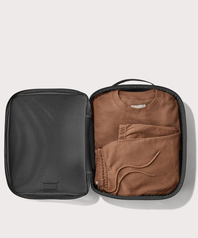 extra large Roma packing cube in carbon black open with sweatsuit inside