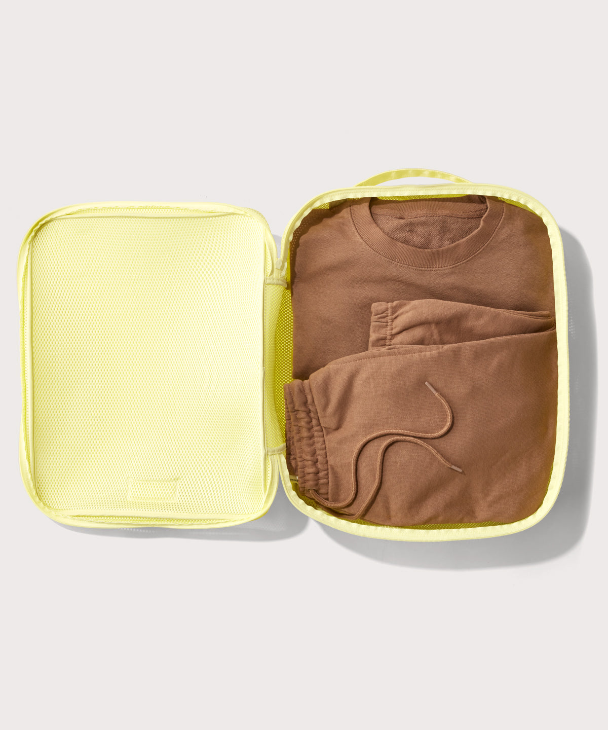 extra large Roma packing cube in citrine open with sweatsuit inside

