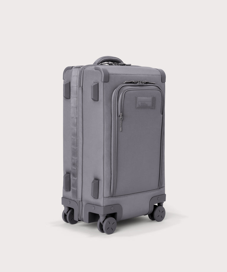 3/4 front view of Seattle carry-on rolling luggage 20.5” in light grey showing side luggage feet
