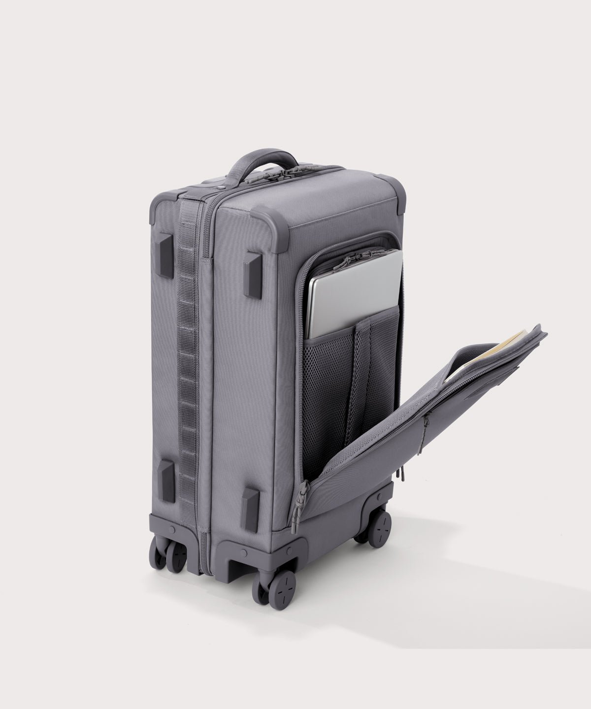 ¾ front view of Seattle carry-on rolling luggage 20.5” in light grey with front flap opened. Caption: Interior slip pocket fits most 13" laptops
