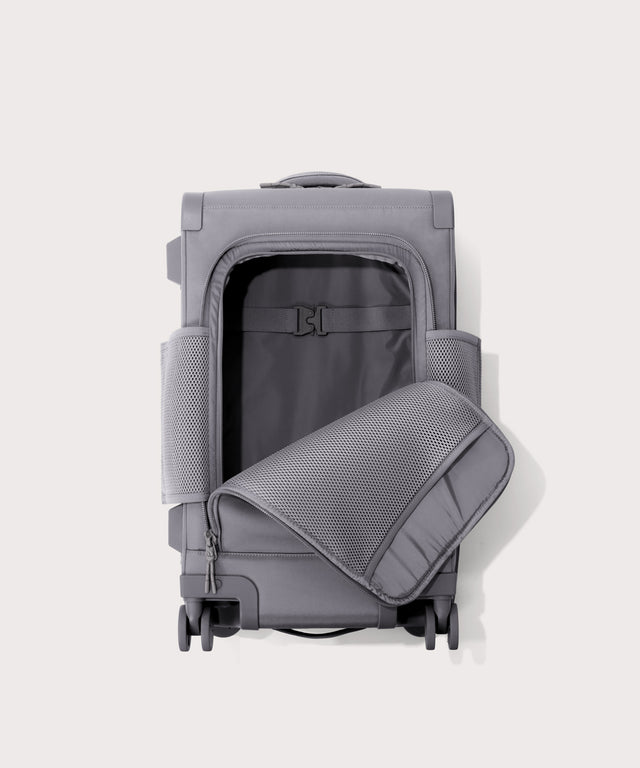 Top down of Seattle carry-on rolling luggage 20.5” in light grey with front flap opened. 
