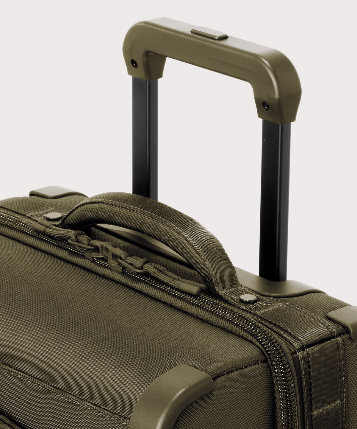 Detail shot of Seattle carry-on rolling luggage 23.5” in dark moss extended luggage handle and puffy handle

