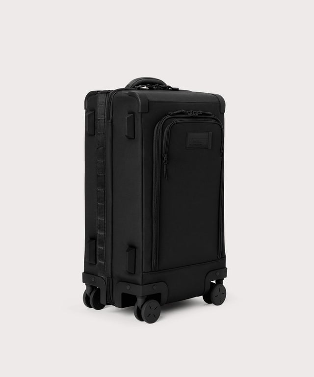 ¾ front view of Seattle carry-on rolling luggage 23.5” in onyx with front flap opened. Caption: Interior slip pocket fits most 16