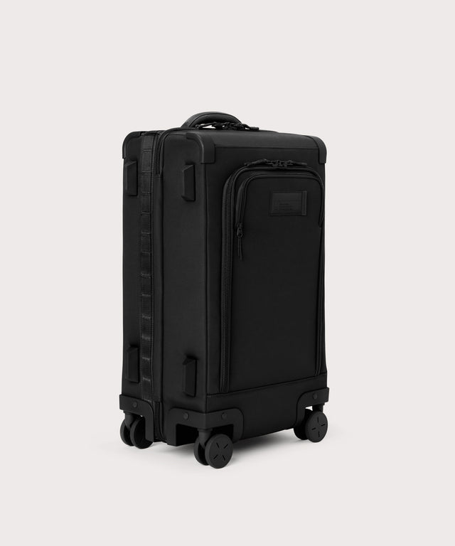 ¾ front view of Seattle carry-on rolling luggage 23.5” in onyx with front flap opened. Caption: Interior slip pocket fits most 16