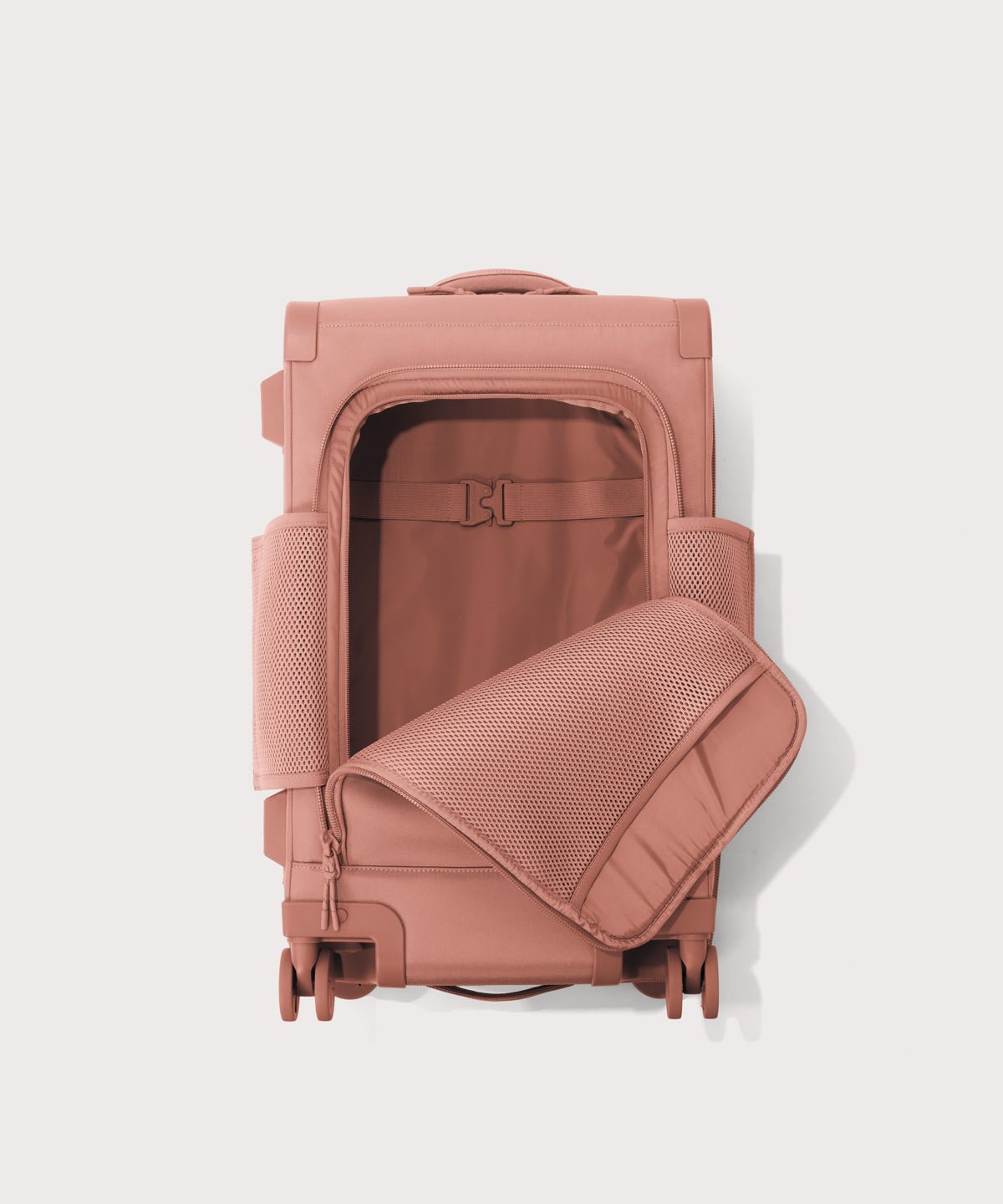 Top down of Seattle carry-on rolling luggage 20.5” in warm dust pink with front flap opened. 
