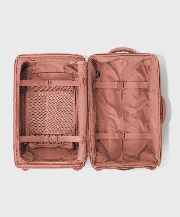 Top down of Seattle carry-on rolling luggage 20.5” in warm dust pink 
