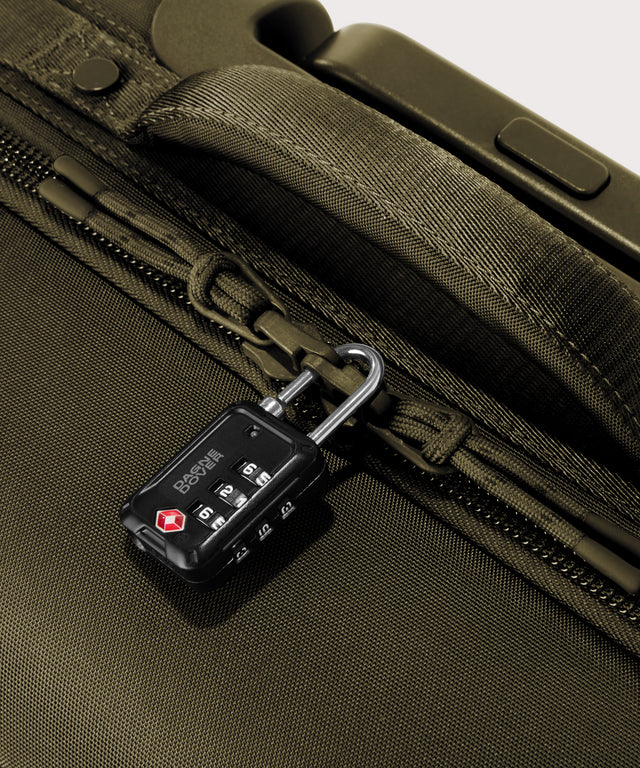 Detail shot of Seattle carry-on rolling luggage 23.5” in dark moss lockable zipper heads. Lock not included.