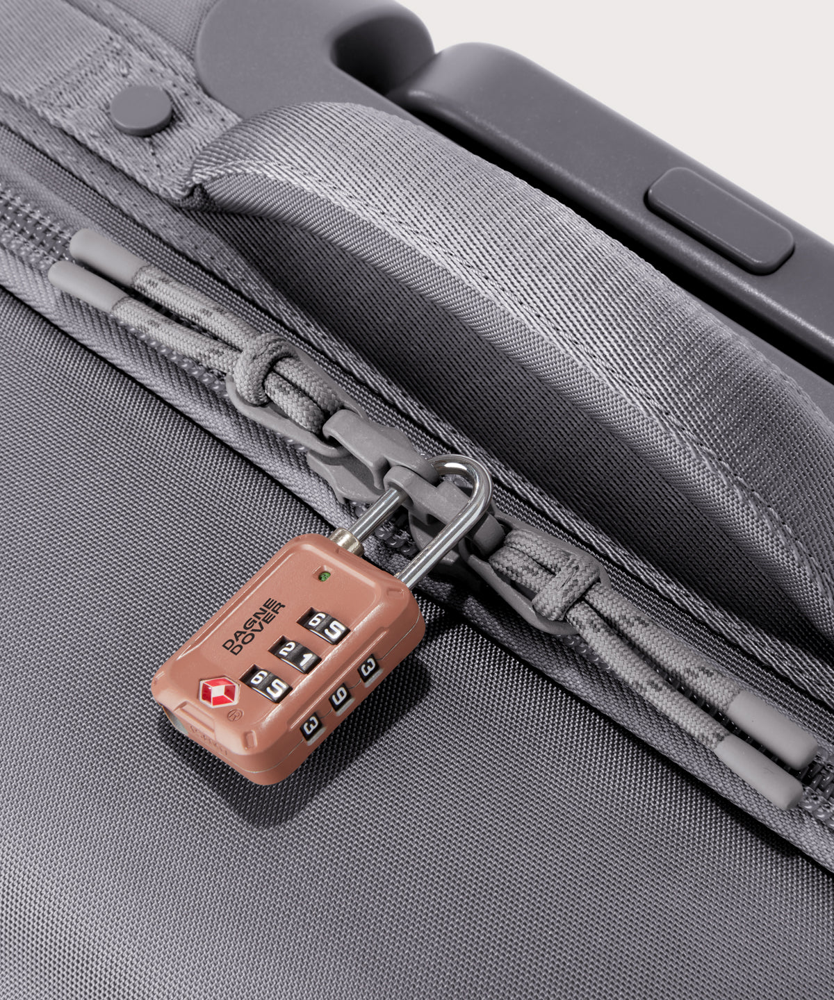 Detail shot of Sydney checked rolling luggage 25" in light grey lockable zipper heads. Lock not included. 
