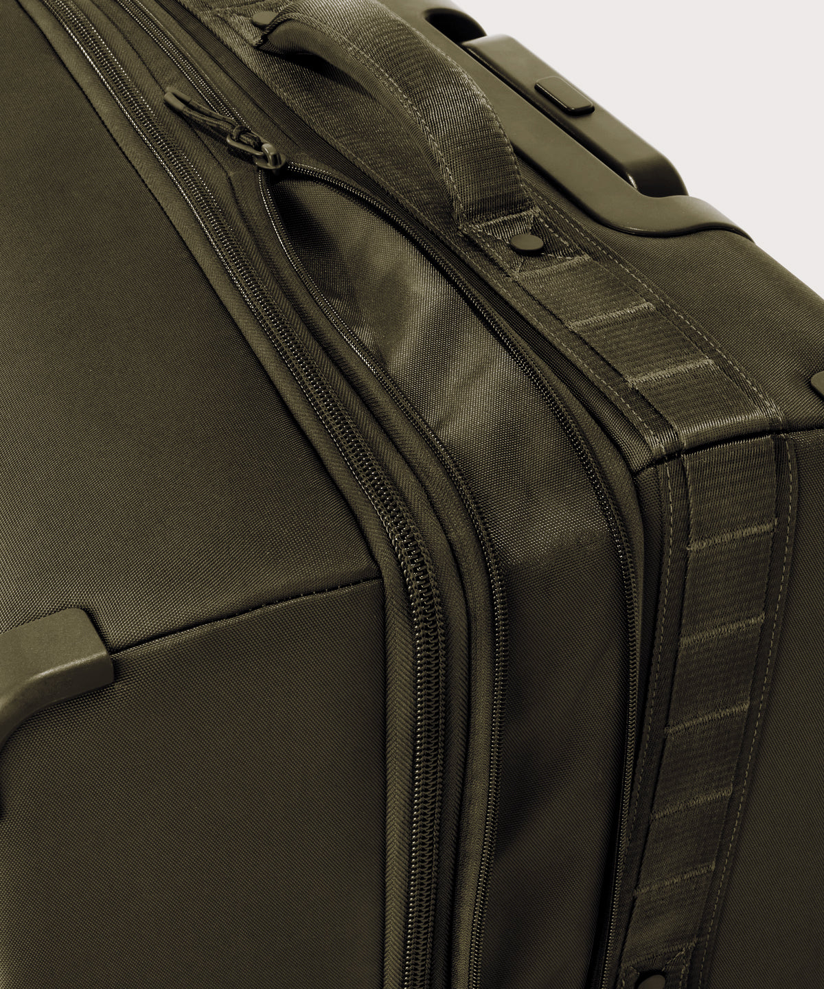 Detail shot of Sydney checked rolling luggage 25" in dark moss expandable zipper feature
