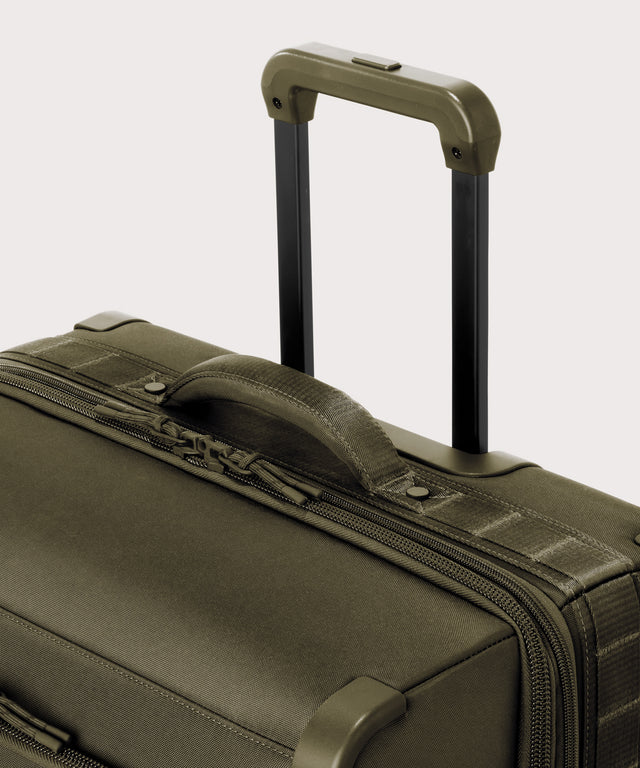 Detail shot of Sydney checked rolling luggage 28.5” in dark green extended luggage handle and puffy handle