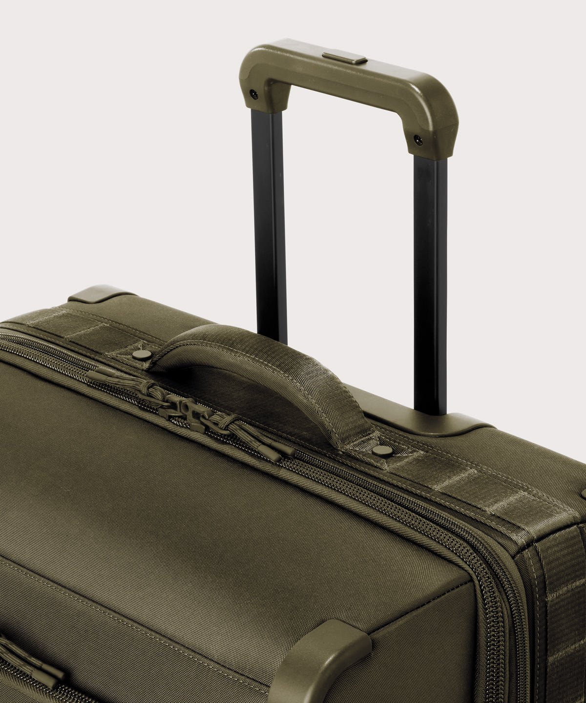 Detail shot of Sydney checked rolling luggage 25" in dark moss extended luggage handle and puffy handle