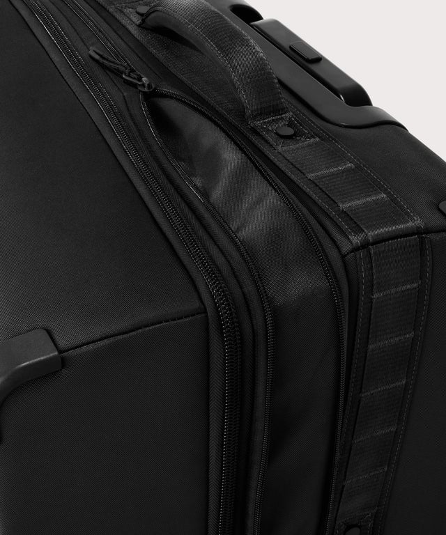 Detail shot of Sydney checked rolling luggage 28.5” in onyx expandable zipper feature
