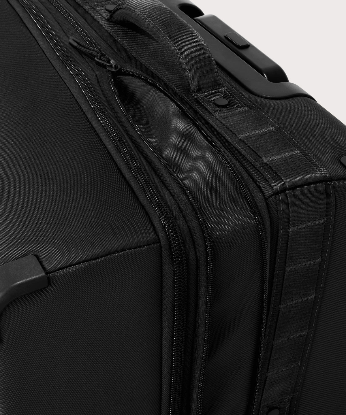 Detail shot of Sydney checked rolling luggage 25" in black expandable zipper feature
