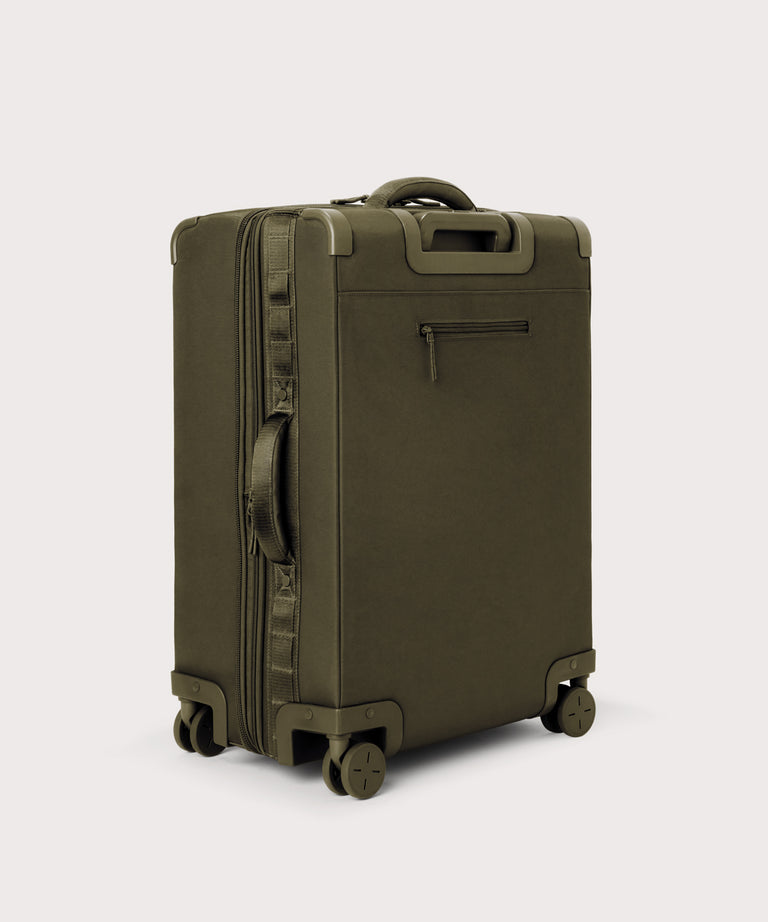 3/4 back view of Sydney checked rolling luggage 25" in dark moss showing side handle and back zippered phone/passport pocket
