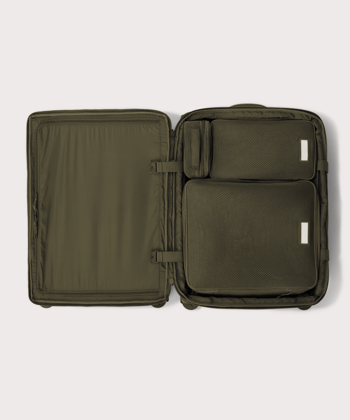 Top down of Sydney checked rolling luggage 25" in dark moss with interior divider zipped and packing cubes packed into the right side. 
