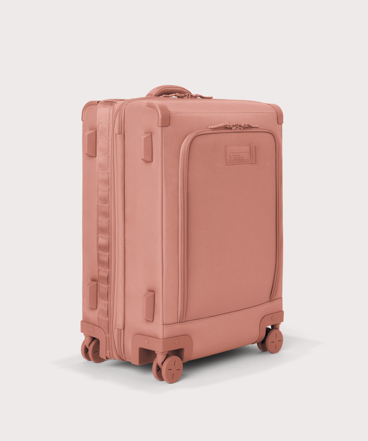 3/4 front view of Sydney checked rolling luggage 25" in warm dust pink showing side luggage feet
