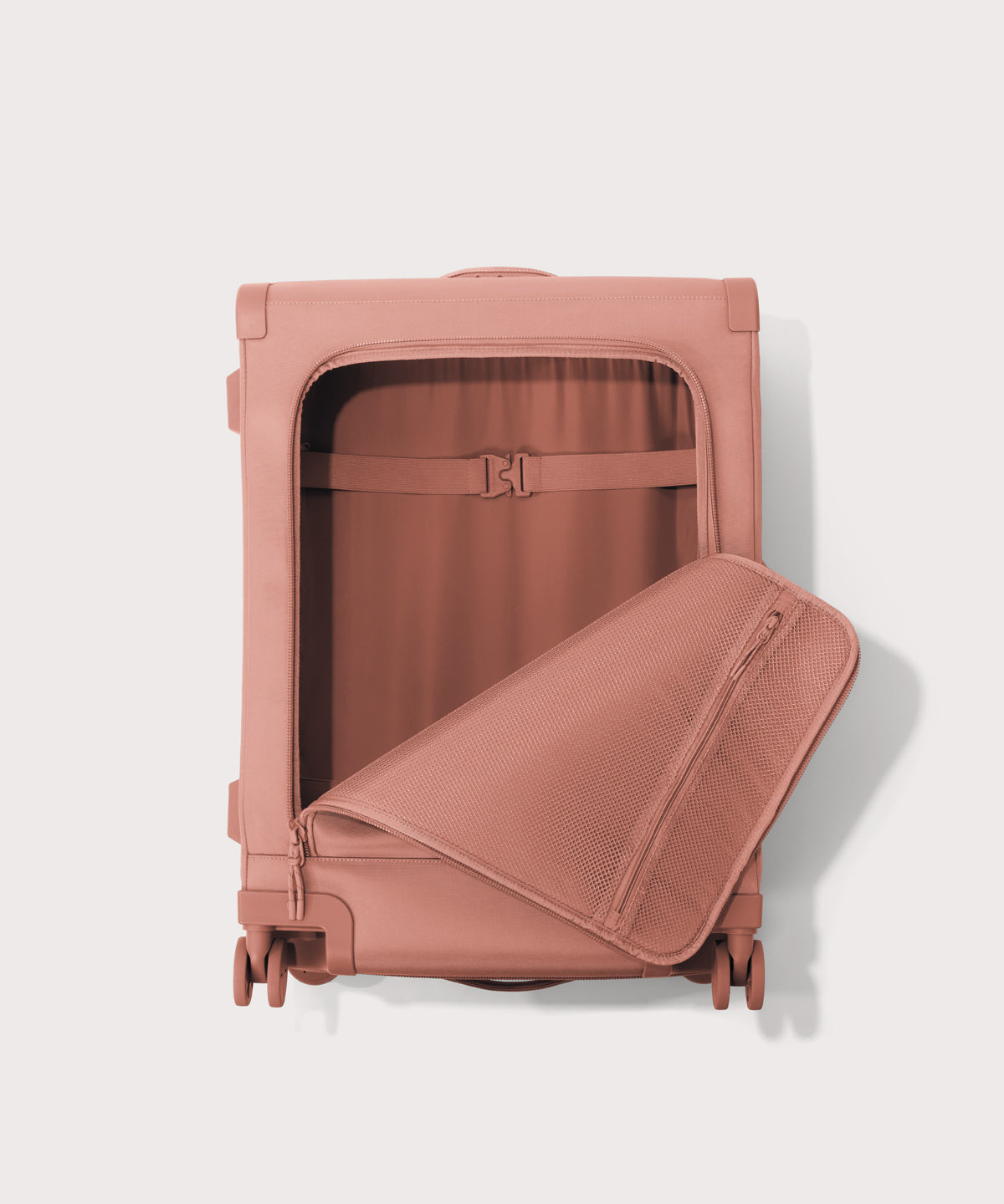 Front view of Sydney checked rolling luggage 25" in warm dust pink with front flap opened
