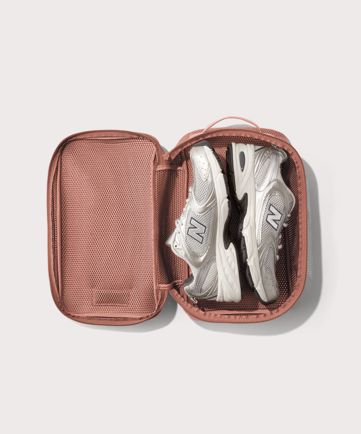 medium Roma packing cube in warm dust pink open with jeans inside
