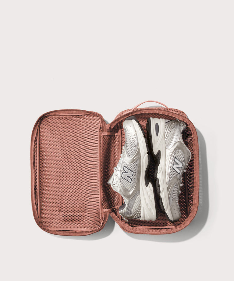 medium Roma packing cube in warm dust pink open with jeans inside